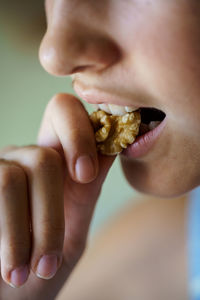 Close-up of young woman eating food