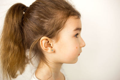 Close-up girl looking away against white background