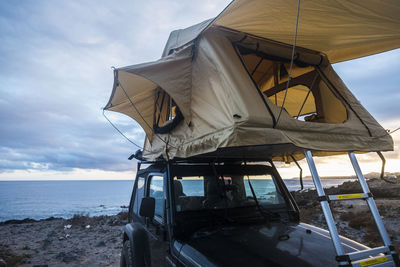 Tent on car against sky