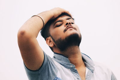 Portrait of young man against white background