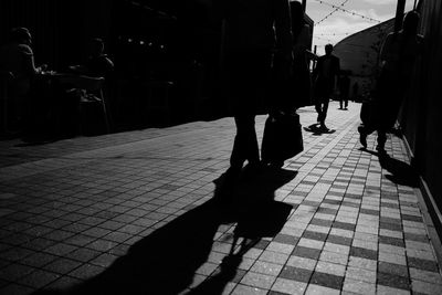People walking on sidewalk in city