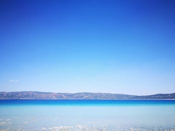 Scenic view of sea against clear blue sky
