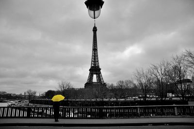 Man tower against cloudy sky