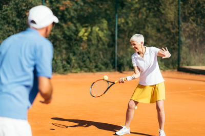 Rear view of man playing with ball