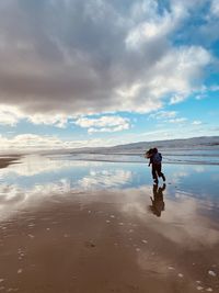 Full length of man on beach against sky