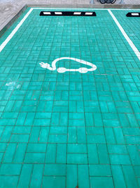 High angle view of arrow symbol on swimming pool