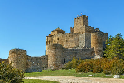 Old ruin building against blue sky