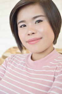 Close-up portrait of a smiling young woman
