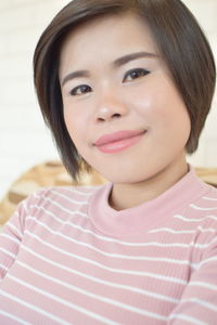 Close-up portrait of a smiling young woman