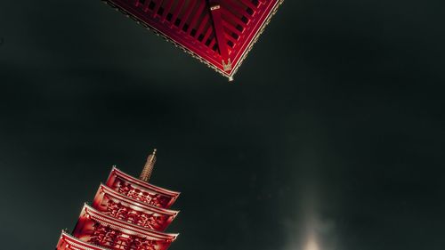 Low angle view of illuminated building against sky at night