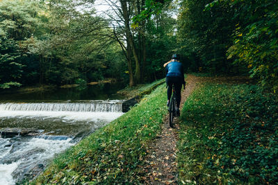 Man riding bicycle in forest