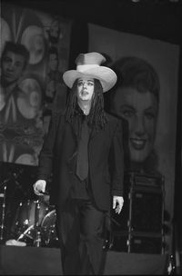 Portrait of young man wearing hat standing at home