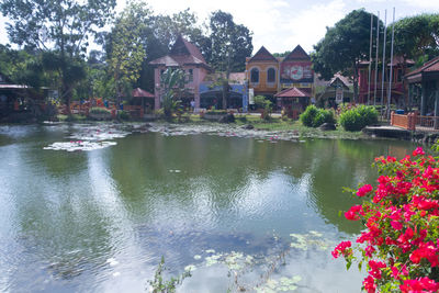 Scenic view of lake by house and buildings