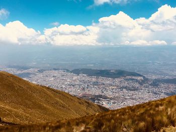 Aerial view of landscape and cityscape against sky