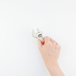 Close-up of hand holding work tool white background