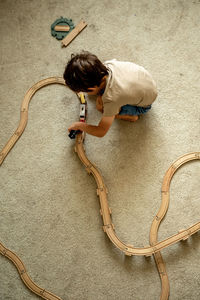 High angle view of boy playing with bubbles