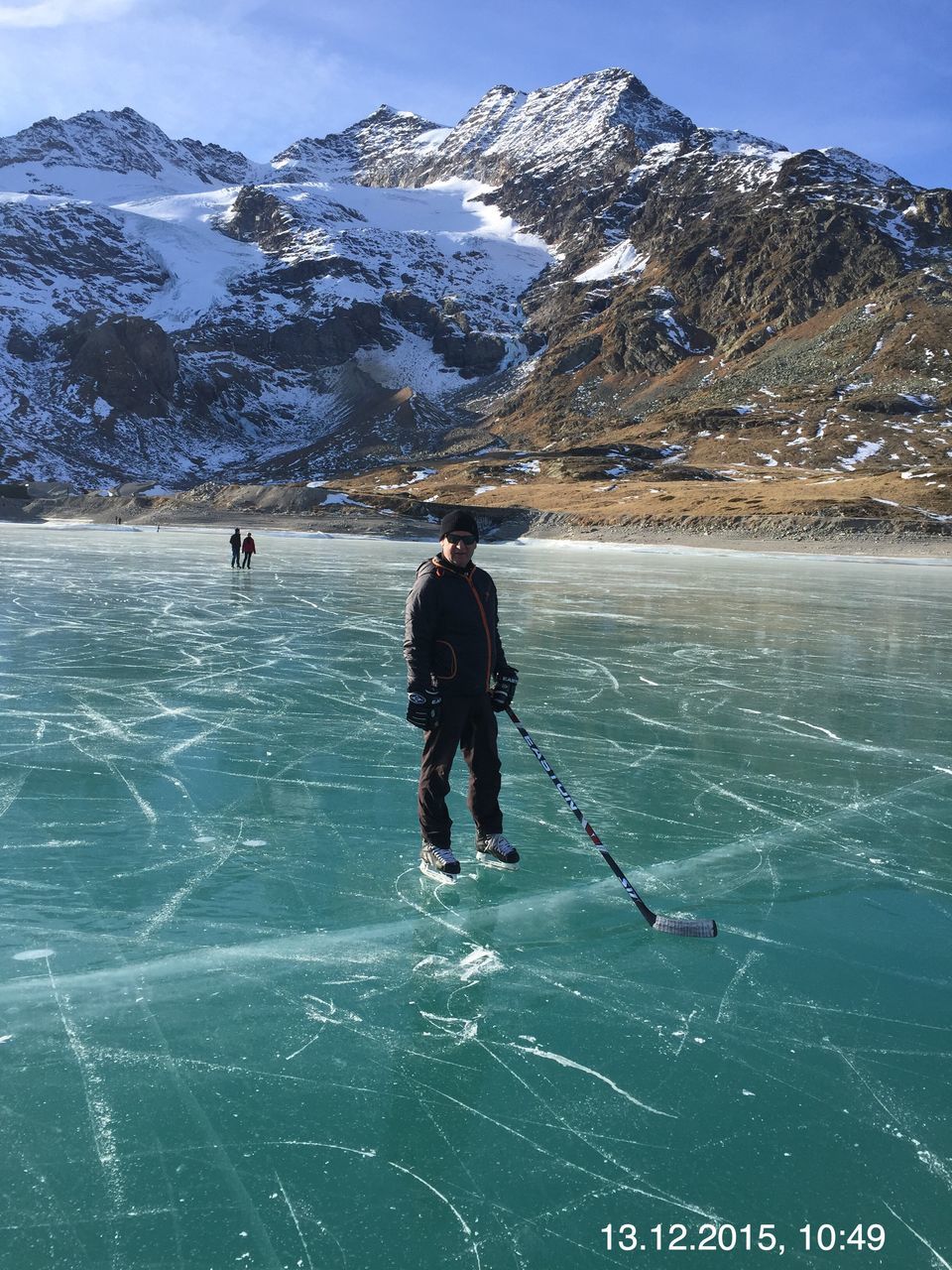 real people, winter, mountain, cold temperature, leisure activity, beauty in nature, lifestyles, scenics - nature, snow, water, nature, full length, non-urban scene, day, ice, frozen, one person, mountain range, warm clothing, snowcapped mountain