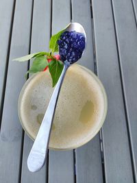 High angle view of caviar in spoon on drink at table