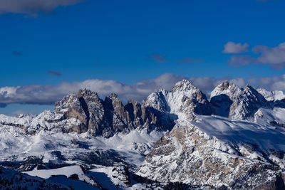 Scenic view of snowcapped mountains against blue sky