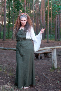 Portrait of woman standing in forest