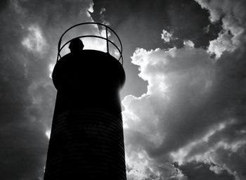 Low angle view of lighthouse against cloudy sky