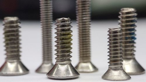 Close-up of screws on table