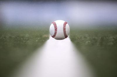 Close-up of baseball on playing field