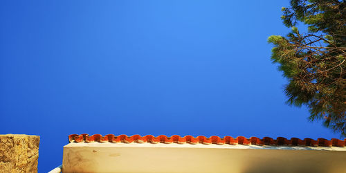 Low angle view of house against blue sky