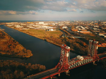 High angle view of bridge over river in city against sky