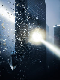 Buildings seen through wet glass window at night