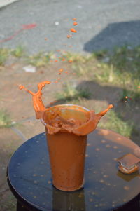 Drink spilling from glass on table