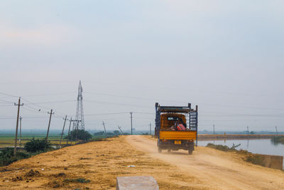 Auto on road by land against sky