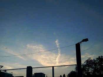 Low angle view of birds perching on power line