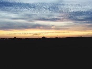 Silhouette landscape against sky during sunset