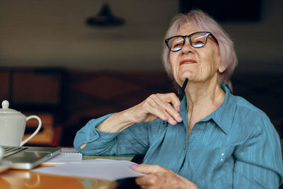 Portrait of young woman using mobile phone