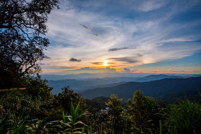 Scenic view of mountains against sky at sunset