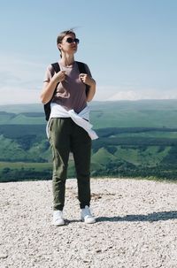 Full length of young women standing overlooking the mountain