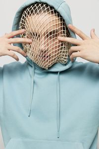 Young woman wearing net over face