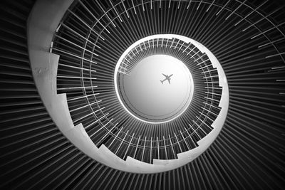 Low angle view of spiral staircase in building against skylight