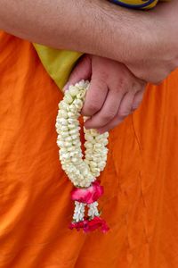 Close-up of hand holding flower