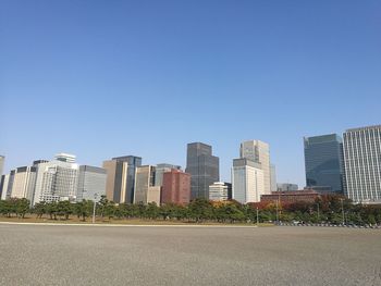 Cityscape against clear blue sky