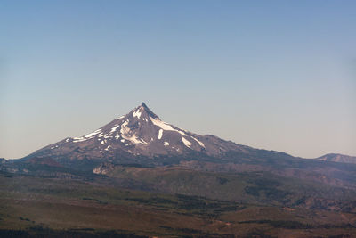 Scenic view of snowcapped mountains against clear sky