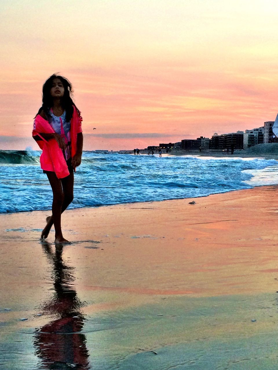 water, sea, lifestyles, beach, leisure activity, full length, sunset, person, shore, standing, vacations, casual clothing, young adult, sky, horizon over water, orange color, sand, wave