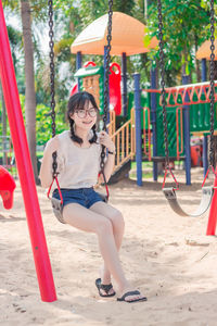 Full length of girl on swing at playground