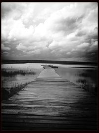 Pier over lake against sky