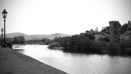 River by buildings against clear sky