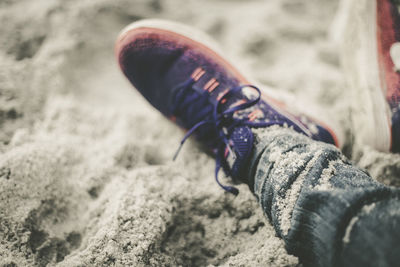 Low section of man wearing shoes