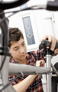 Boy is assembling his new mountain bike at home