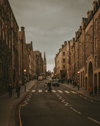 View of city street and buildings against sky