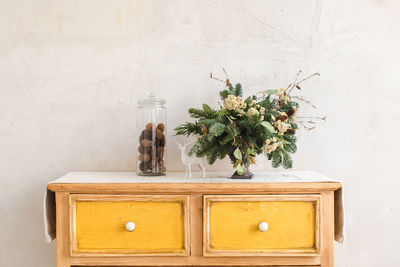 Dresser with conifer branches and christmas decorations